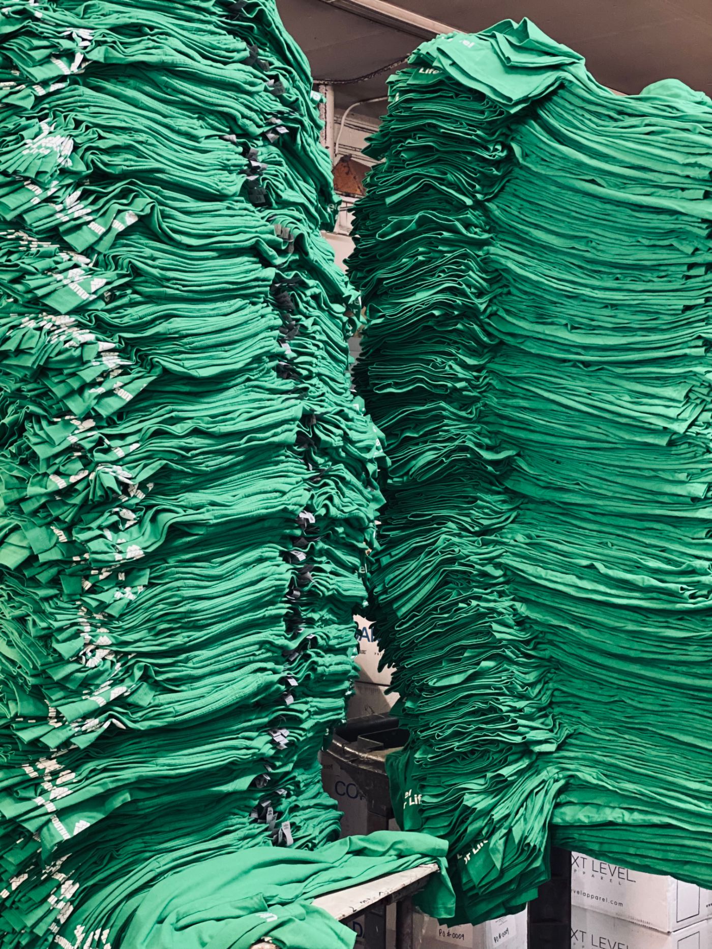 Screen printing press carousel running shirts at the Las Vegas Contract Printing shop floor