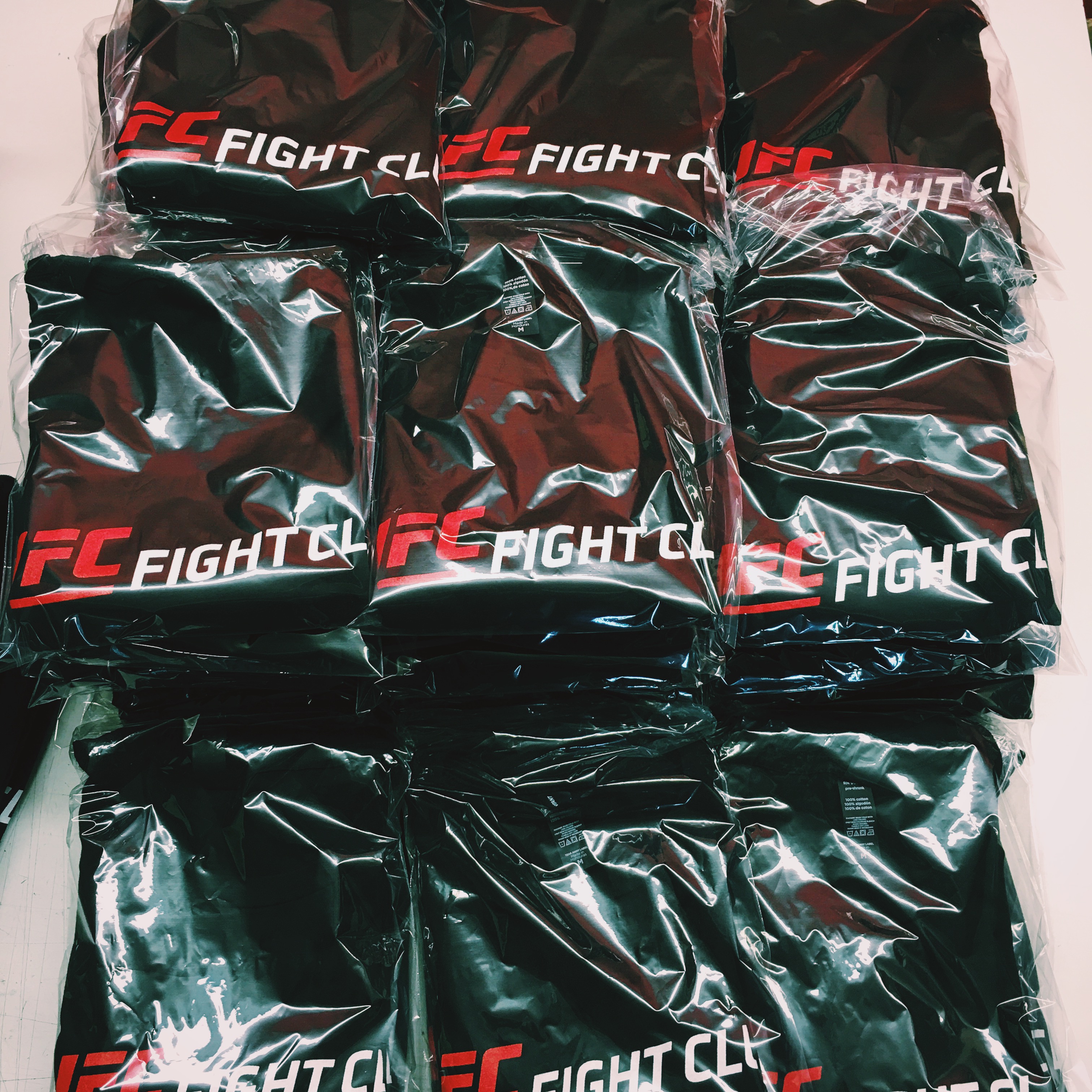 Poly-bagged printed garments ready for retail — fold, bag, and tag finishing